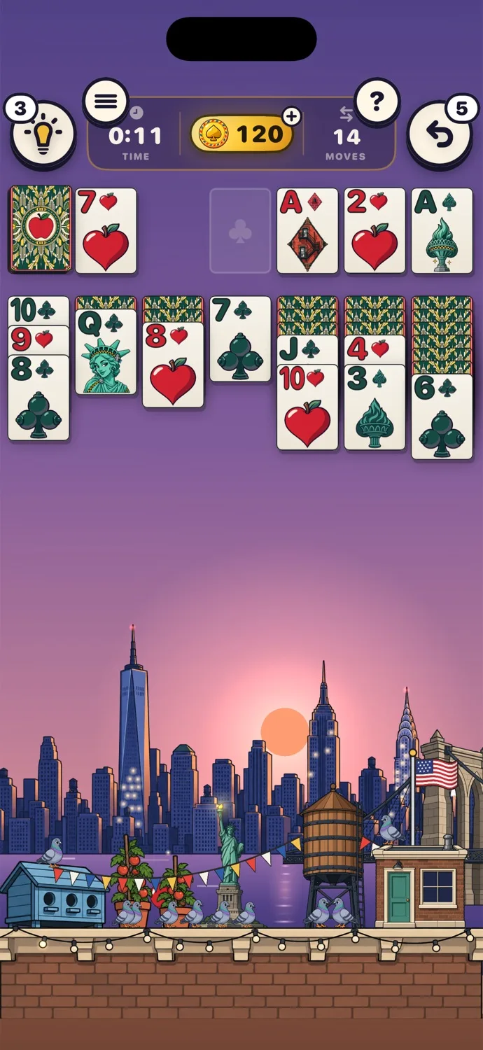 A game of Klondike on the New York table at sunset, with the skyline, the Statue of Liberty, a water tower and pigeons below the cards.